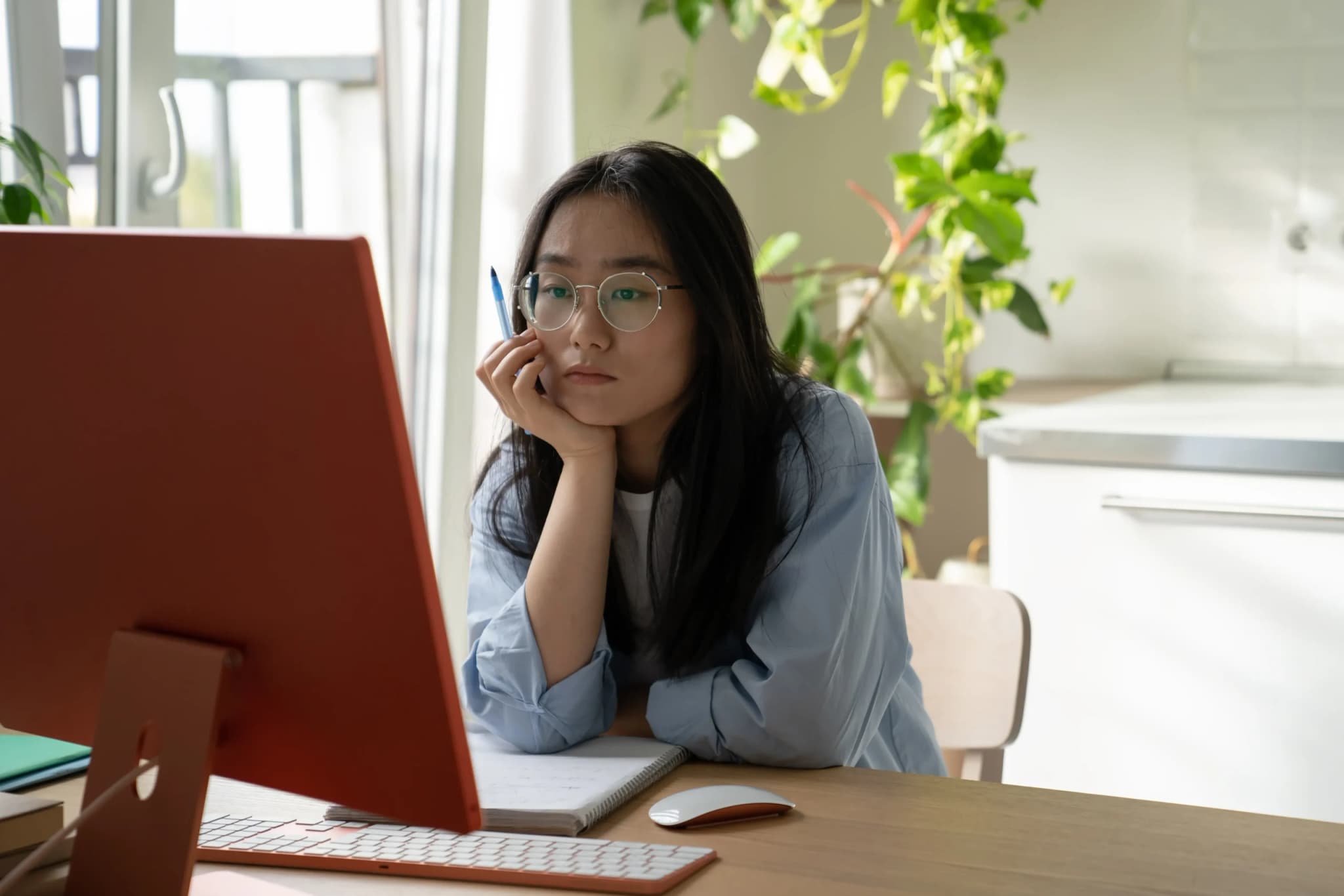 Lady focused work behind desktop monitor